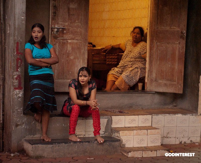 These young women are prostitutes in the red-light district; some most likely entrapped since childhood.