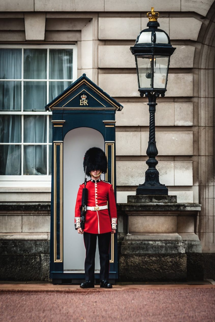 royal guard standing near lamp post