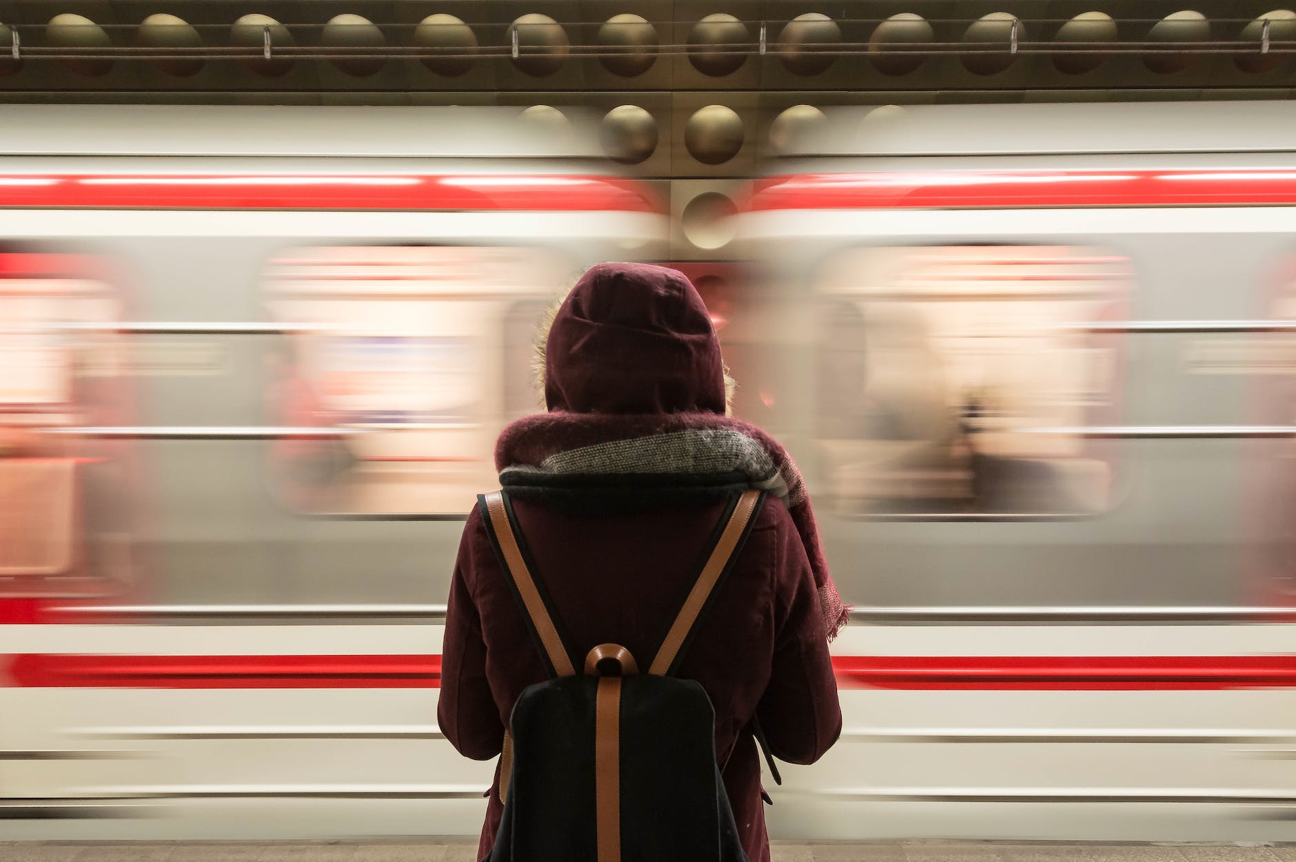 standing woman facing a speeding train