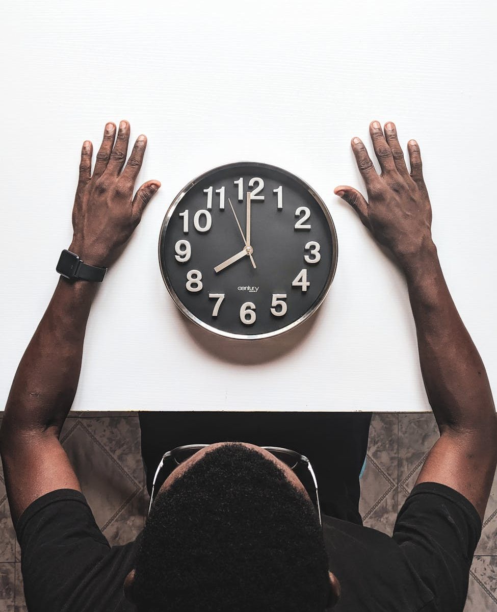 round silver colored wall clock