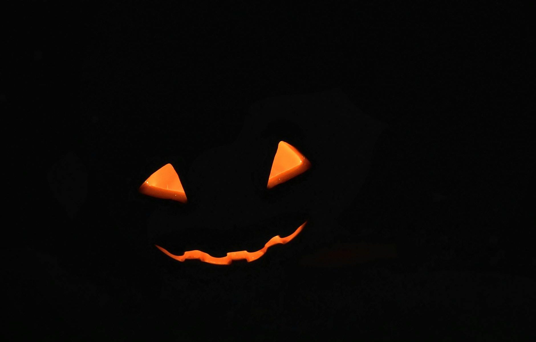glowing jack o lantern face in darkness